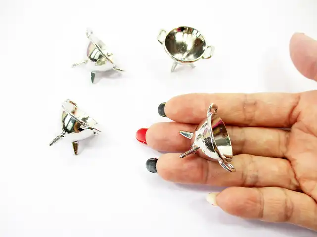 Hand holding a 1:12 scale silver champagne cooler bucket to demonstrate the realistic metal texture and miniature scale.