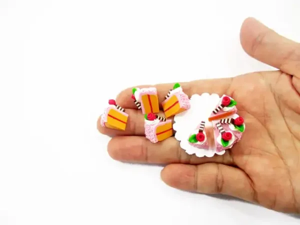 collector handmade clay miniature slice cake decorated with roses for craft and dollhouse scenes