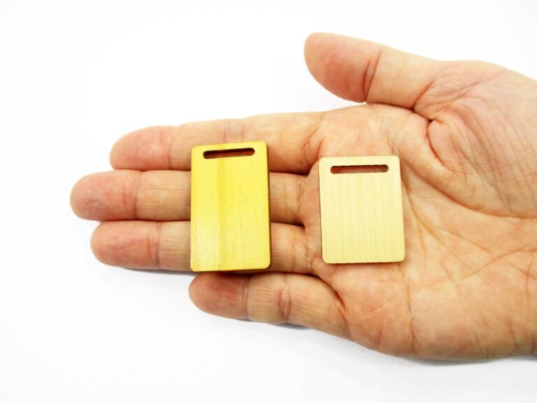 Handcrafted 1:12 scale miniature wooden cutting boards in both 30x23mm and 23x38mm sizes shown on an adult palm for display.