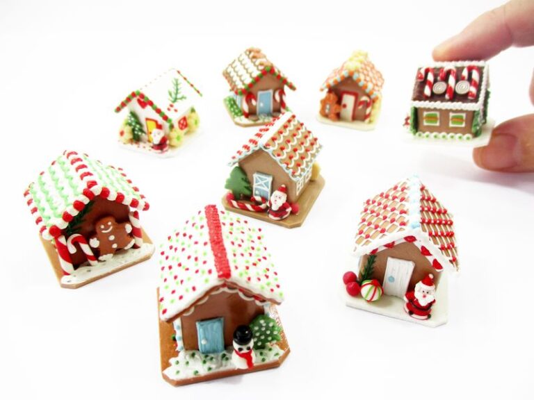 A group of diverse 1:12 scale miniature clay gingerbread houses with festive icing for a dollhouse Christmas display.